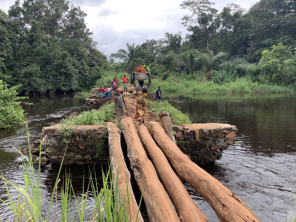 Bogose Nubea is a remote village of about 6,000 people and has a series of 12 log bridges and a half-kilometer causeway crossing the Nguya River and wetlands. Over half of the population use these log bridges as their connection to the west where the primary market, Bogose Nubea Hospital, schools, and churches are located.